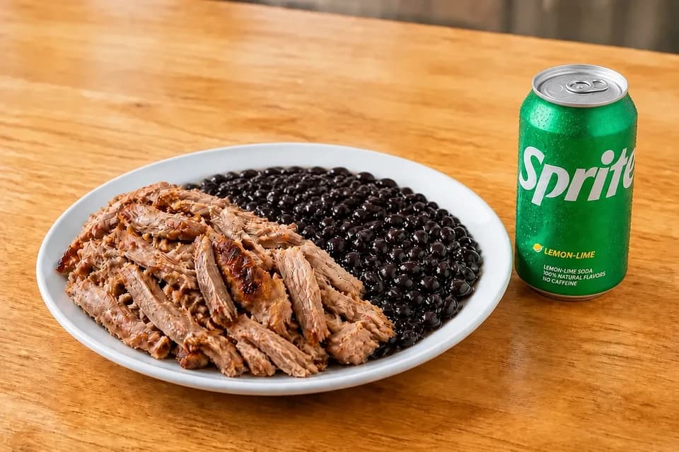 Roasted pernil with black beans and a Sprite can